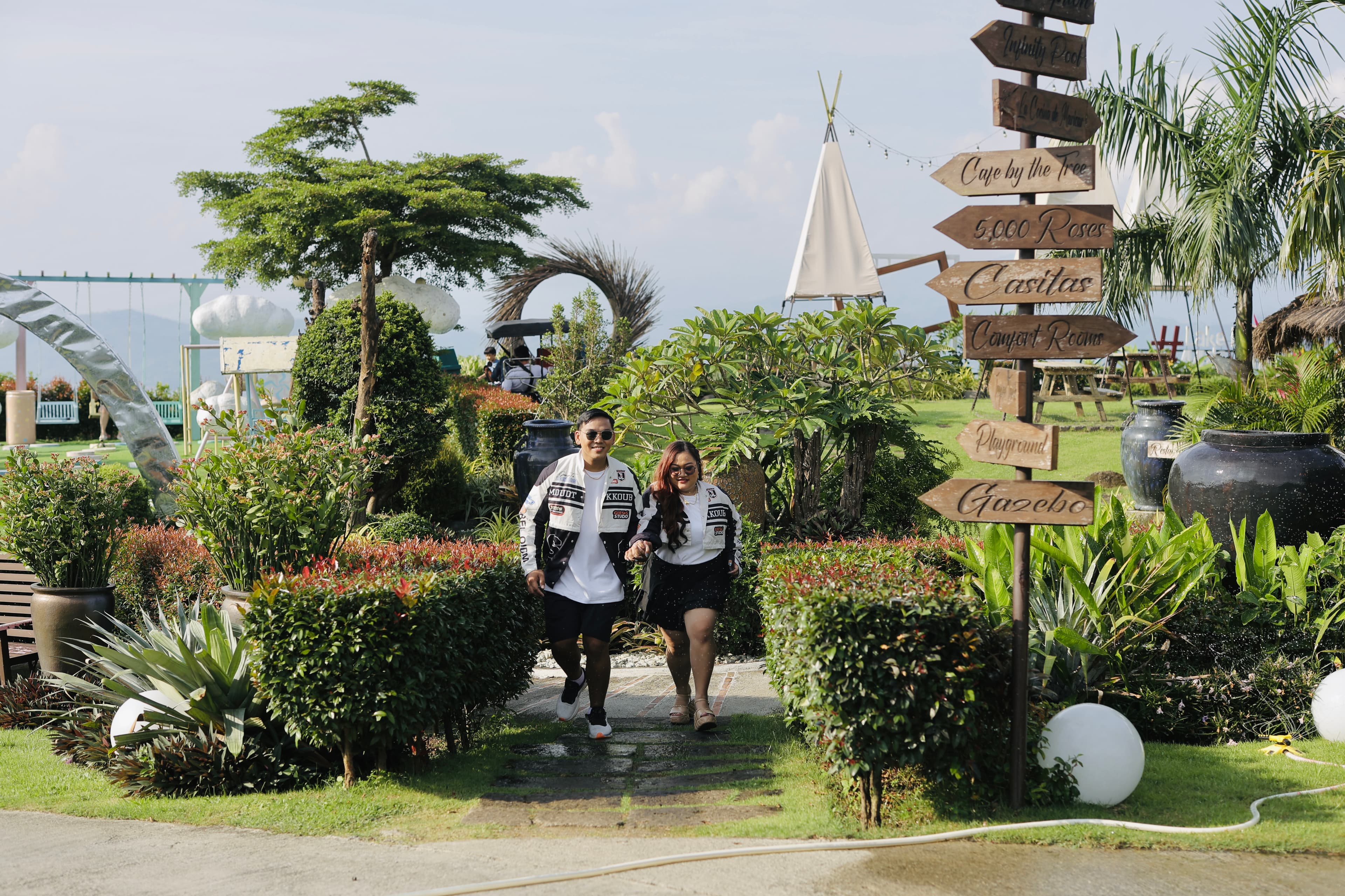 Mardy and Mayumi walking through the gardens in matching jackets