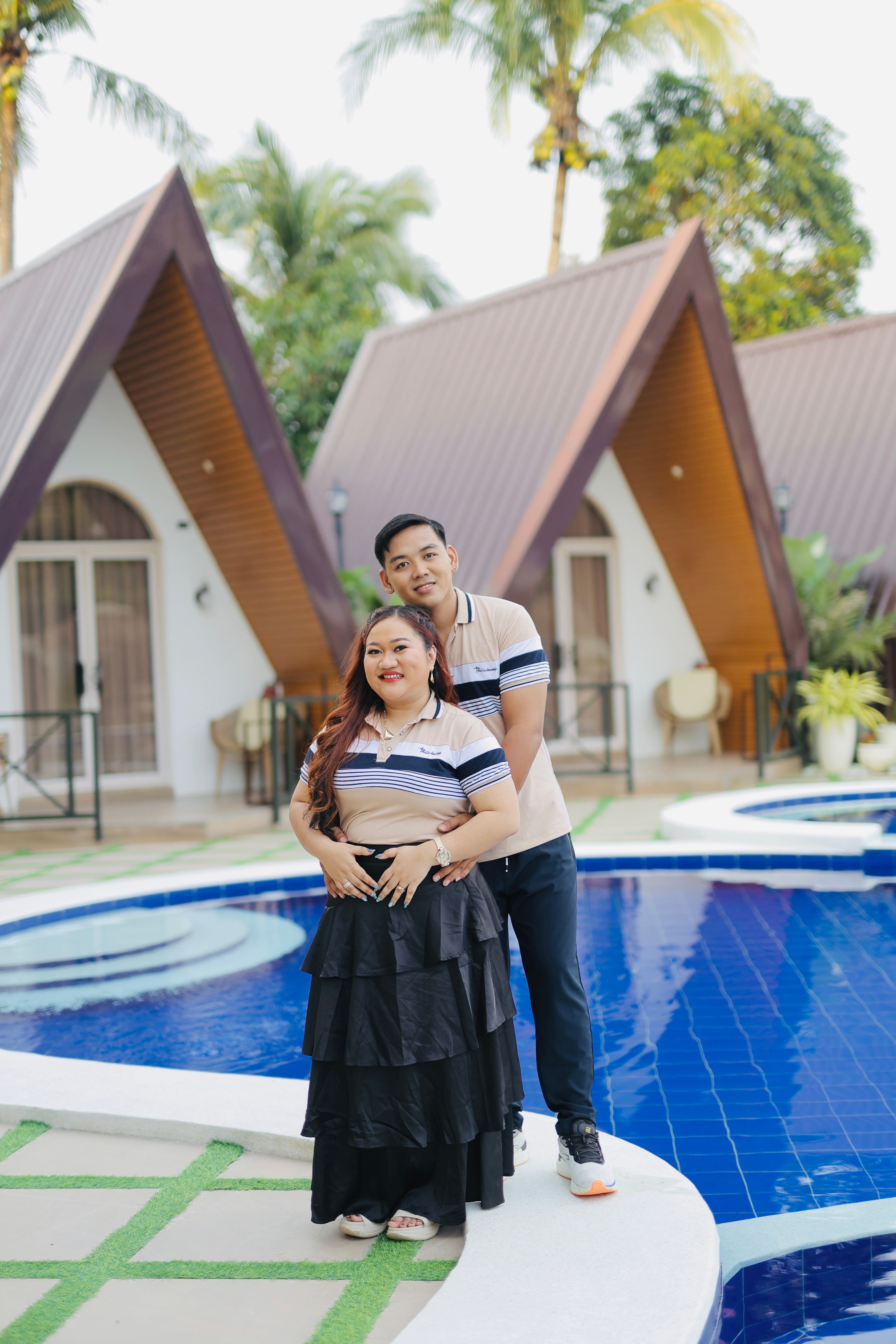 Mayumi and Mardy posing together beside the pool during their prenup session