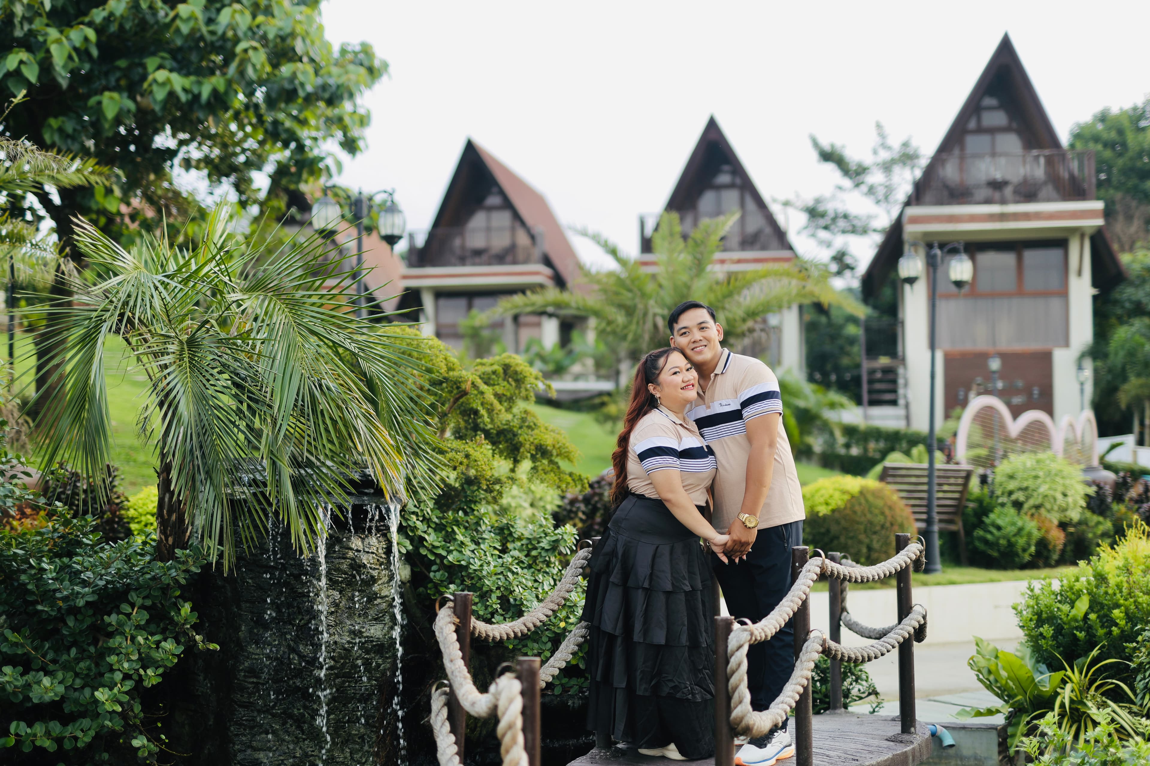 Mayumi and Mardy embracing on a garden bridge during their prenup session